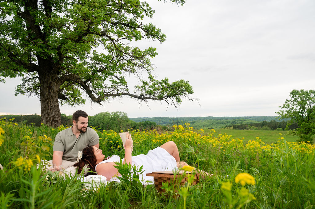 romantic-french-picnic-engagement-couple-reading-under-tree-pope-farm-middleton-wisconsin