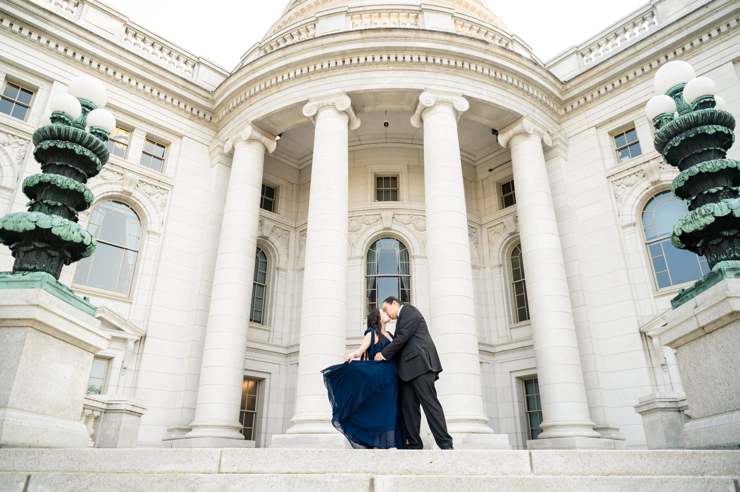 Autumn and Michael kissing on the steps of the Wisconsin State Capitol