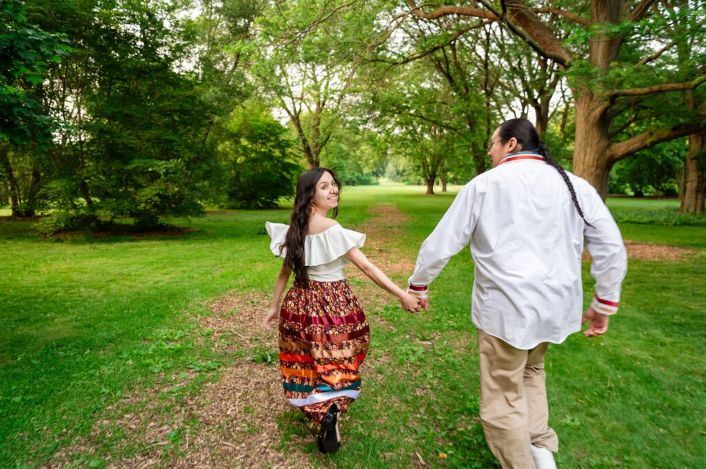 Couple walking through the UW Arboretum trails in matching ribbon outfit