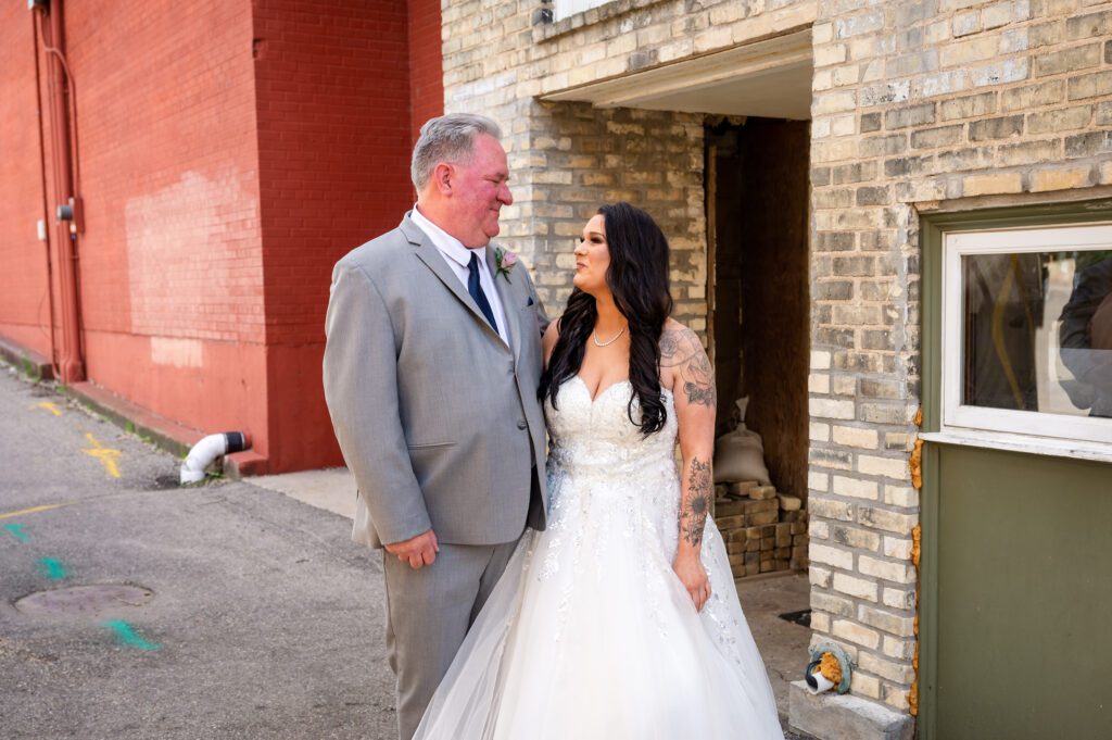 Bride shares emotional first look with her father at Chorus Public House in Stoughton, WI.