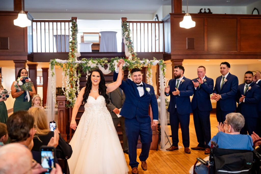 Bride and groom share a dance during their wedding reception at Chorus Public House in Stoughton, WI, surrounded by love, joy, and celebration.
