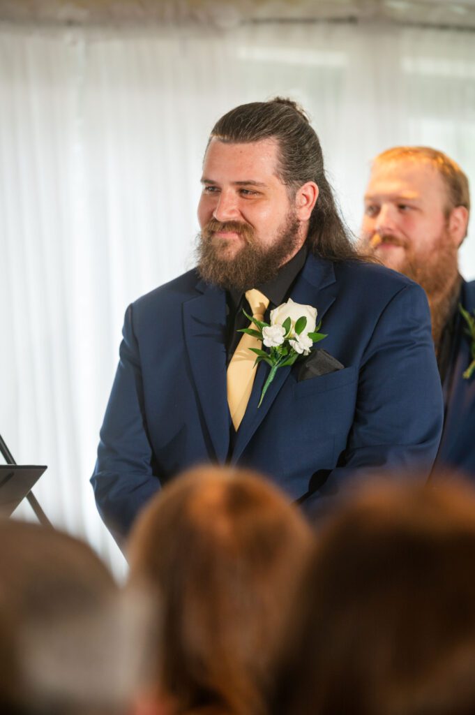 Groom Jared smiles warmly as he watches bride Marissa during their heartfelt ceremony at Chorus Public House, Stoughton WI.