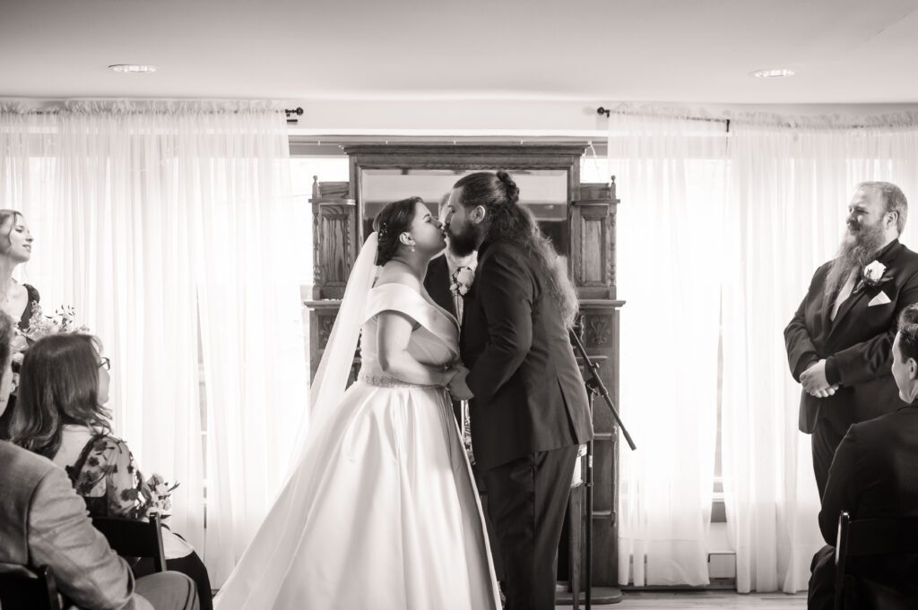 Bride Marissa and groom Jared share their first kiss as a married couple during their Dungeons & Dragons themed ceremony at Chorus Public House.