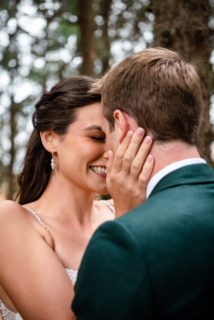 Bride and groom embrace each other, hands on face.  (10 questions to ask before booking)